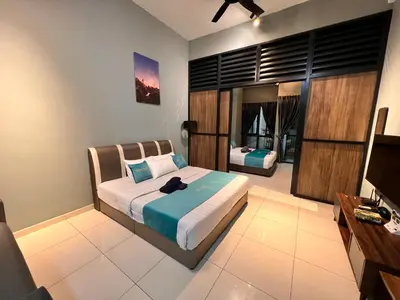 a bedroom with a bed and a desk and a television at BLUE JADE STUDIOS in Tanah Rata