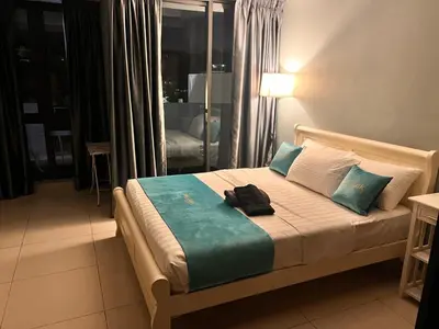 a bedroom with a bed with a bag on it at BLUE JADE STUDIOS in Tanah Rata