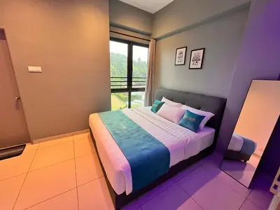 a bedroom with a bed in a room with a window at BLUE JADE STUDIOS in Tanah Rata