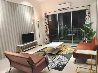 a living room with a couch and a television and a balcony at Pavilionvillie M1T6100 by irainbow in Ipoh