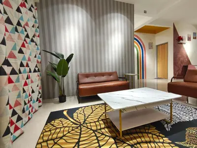 a living room with a table and a couch at Pavilionvillie M1T6100 by irainbow in Ipoh