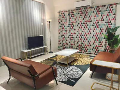 a living room with a couch and a table and a tv at Pavilionvillie M1T6100 by irainbow in Ipoh