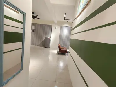 a hallway with a chair and green and white stripes at Pavilionvillie M1T6100 by irainbow in Ipoh