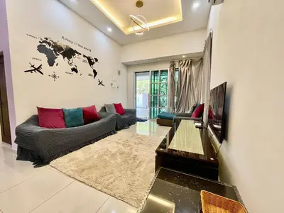 a living room with a couch and a tv at Comfort 36 Entire House At Alma Bukit Mertajam in Bukit Mertajam