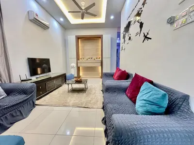 a living room with two blue couches and a tv at Comfort 36 Entire House At Alma Bukit Mertajam in Bukit Mertajam