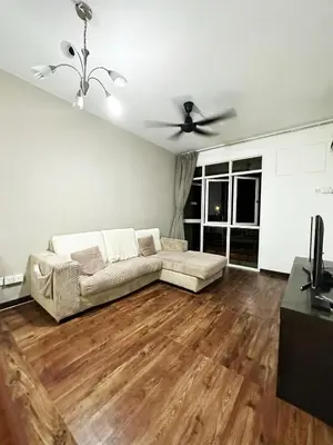 a living room with a couch and a ceiling fan at Bayu Emas Ferringhi Homestay in Batu Ferringhi