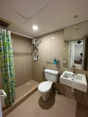 a bathroom with a toilet and a sink at Bayu Emas Ferringhi Homestay in Batu Ferringhi
