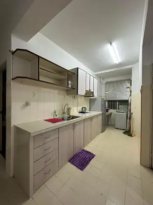 a large kitchen with a sink and a refrigerator at Bayu Emas Ferringhi Homestay in Batu Ferringhi
