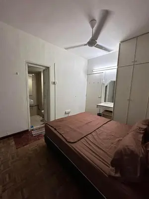 a bedroom with a bed and a ceiling fan at Bayu Emas Ferringhi Homestay in Batu Ferringhi