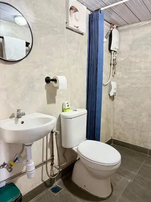 a bathroom with a white toilet and a sink at Ardour Lodge 