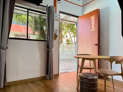 a table and chairs in a room with a window at Ardour Lodge 