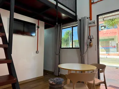 a room with a table and chairs and a window at Ardour Lodge 