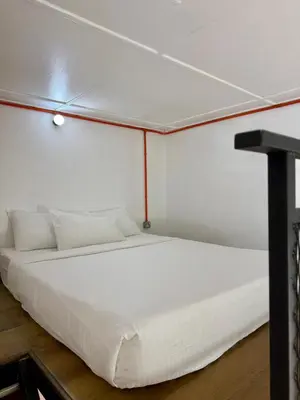 a bedroom with a white bed in a room at Ardour Lodge 