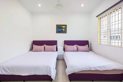 two beds sitting next to each other in a room at Seaside Private Bungalow, Tg Bungah in Tanjung Bungah