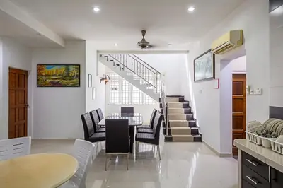 a kitchen and dining room with a table and chairs at Seaside Private Bungalow, Tg Bungah in Tanjung Bungah