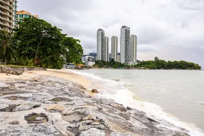 a beach with tall buildings in the background at Seaside Private Bungalow, Tg Bungah in Tanjung Bungah
