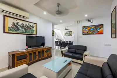 a living room with a couch and a tv at Seaside Private Bungalow, Tg Bungah in Tanjung Bungah