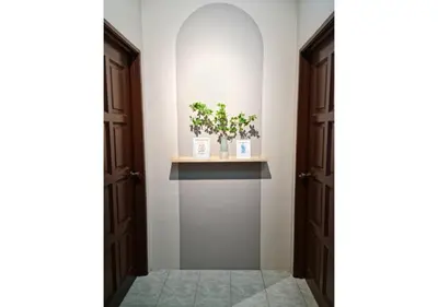 an open door with plants on a shelf in a hallway at Air-home No 9 Kampung Boyan, 4BR, 9pax, Netflix in Taiping