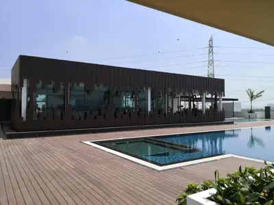 a large building with a swimming pool in front of it at Cozy Suite Studio Meritus Residensi Perai in Perai