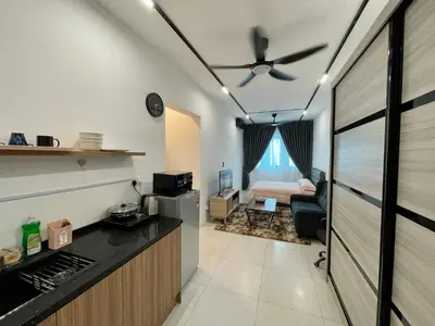 a kitchen and a living room with a ceiling fan at Cozy Suite Studio Meritus Residensi Perai in Perai