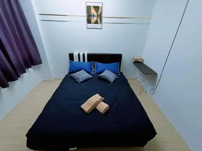 a bedroom with a black bed with blue pillows at Jo-Rumah 3 Bedroom Apartment Jelutong Georgetown Penang Free WIFI in Jelutong