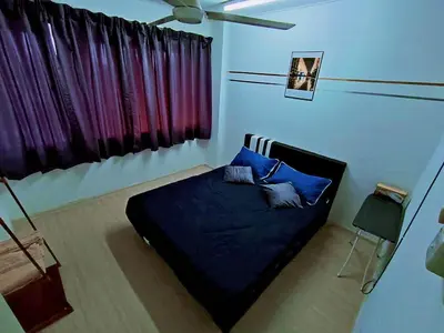 a bedroom with a bed with blue sheets and blue pillows at Jo-Rumah 3 Bedroom Apartment Jelutong Georgetown Penang Free WIFI in Jelutong