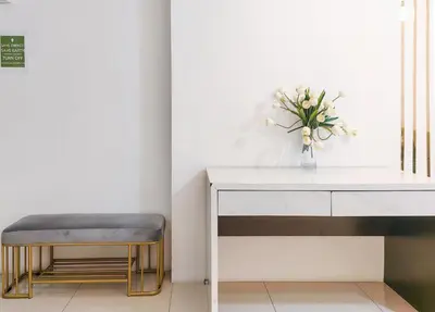 a table and a stool with a vase of flowers at Ipoh Town Apartment 8pax by Cozy in Ipoh