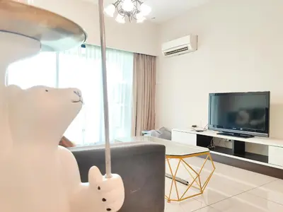 a living room with a couch and a television at Ipoh Town Apartment 8pax by Cozy in Ipoh
