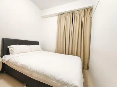 a bedroom with a white bed and a window at Ipoh Town Apartment 8pax by Cozy in Ipoh