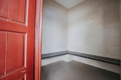 an empty closet with a red door and a tile floor at Ipoh Town Apartment 8pax by Cozy in Ipoh