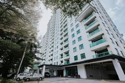 a large white building with cars parked in front of it at Ipoh Town Apartment 8pax by Cozy in Ipoh