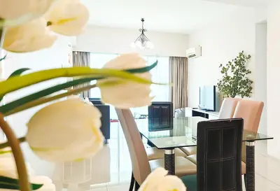 a dining room with a glass table and chairs at Ipoh Town Apartment 8pax by Cozy in Ipoh