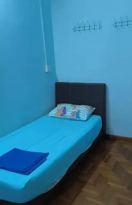 a blue room with a bed with a blue light at Rent Room in Ipoh