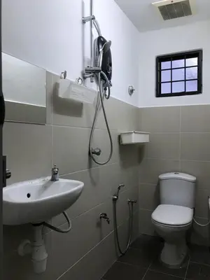 a bathroom with a shower and a toilet and a sink at Rent Room in Ipoh