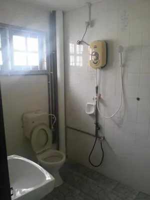 a bathroom with a shower and a toilet and a sink at Rent Room in Ipoh