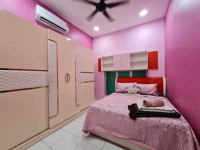 a pink bedroom with a bed and a ceiling fan at HOMESTAY EPOH MANJOI WITH PRIVATE POOL AND JACUZZI in Ipoh