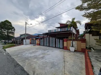 a building with a parking lot in front of it at HOMESTAY EPOH MANJOI WITH PRIVATE POOL AND JACUZZI in Ipoh