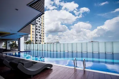 a large swimming pool on top of a building at One Majestic Ipoh - 3 Bedroom Apt For Family of 5 in Ipoh