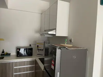 a kitchen with a refrigerator and a microwave at One Majestic Ipoh - 3 Bedroom Apt For Family of 5 in Ipoh