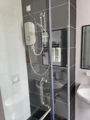 a shower with a glass door in a bathroom at One Majestic Ipoh - 3 Bedroom Apt For Family of 5 in Ipoh