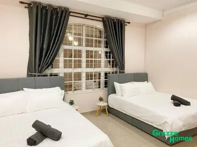 a bedroom with two beds and a window at Ipoh Town Bangalow Canning Garden Football Table in Ipoh