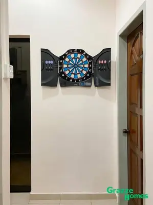 a wall with a dart board on a wall at Ipoh Town Bangalow Canning Garden Football Table in Ipoh
