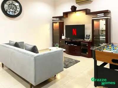 a living room with a couch and a tv at Ipoh Town Bangalow Canning Garden Football Table in Ipoh