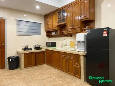 a kitchen with wooden cabinets and a black refrigerator at Ipoh Town Bangalow Canning Garden Football Table in Ipoh