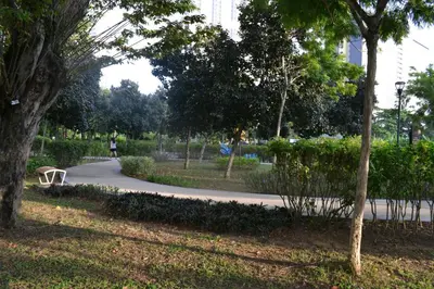 a park with a bench in the middle of a path at MARITIME SUITES DUPLEX MARVELOUS SEA VIEW in George Town