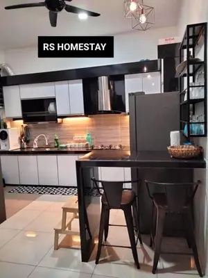 a kitchen with a table and chairs in a kitchen at RS Homestay in Sungai Petani