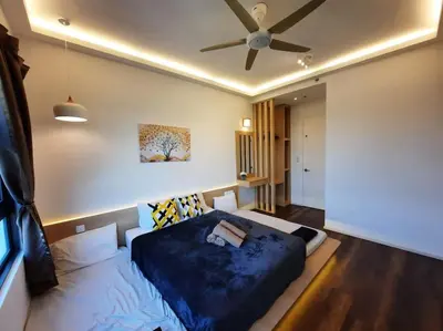 a bedroom with a bed and a ceiling fan at Onsen Suite at Sunway Lost World Tambun in Ipoh