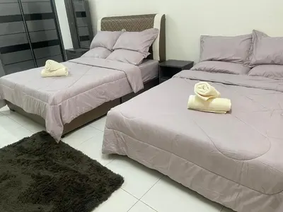 two beds with towels on them in a room at ZaraVip homestay in Lahat