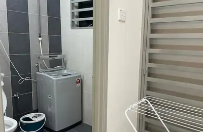 a small bathroom with a trash can in a room at ZaraVip homestay in Lahat