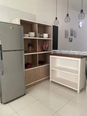 a kitchen with a white refrigerator and a counter at ZaraVip homestay in Lahat